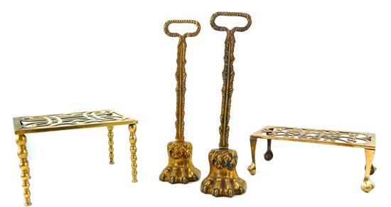 Appraisal: Four brass accessories pair handled doorstops cast oval handle supported