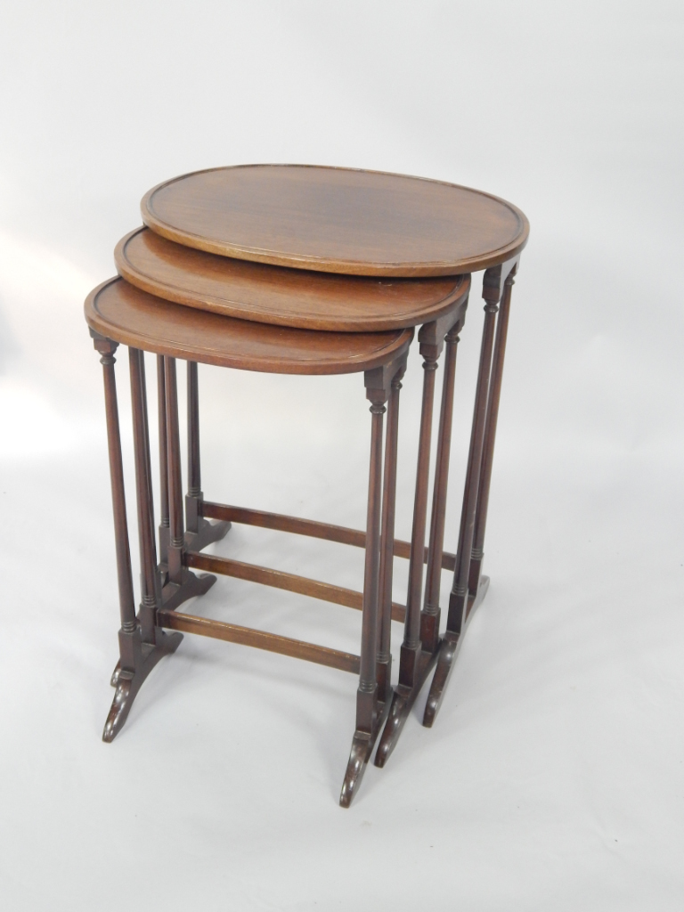 Appraisal: A nest of oval mahogany occasional tables raised on slender