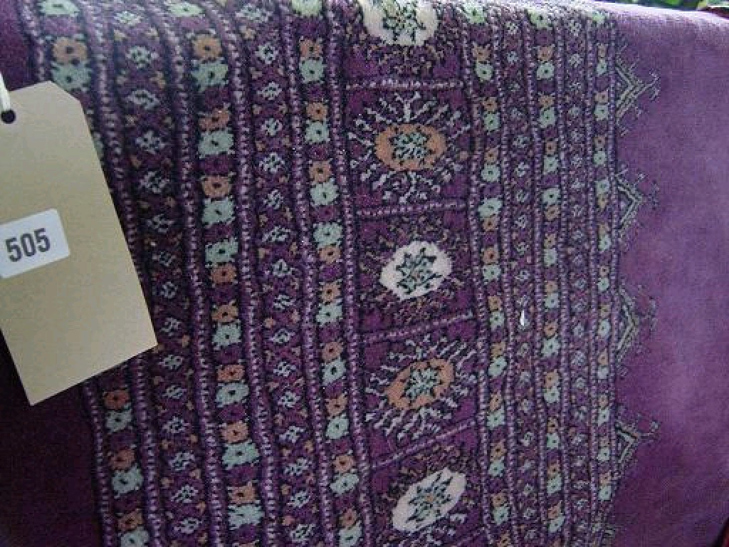 Appraisal: A purple ground wool carpet with repeating border decoration in