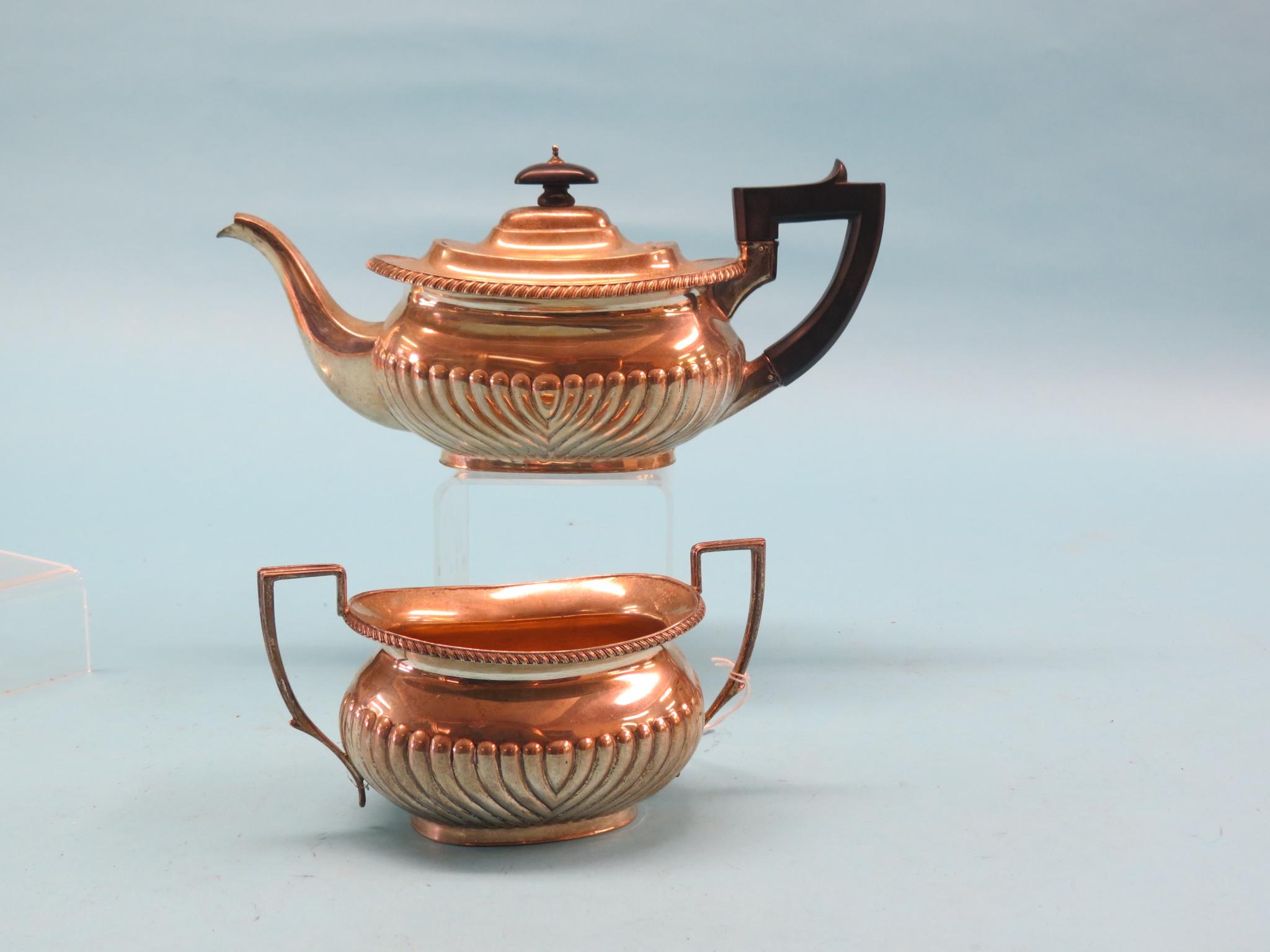 Appraisal: A silver teapot and matching sugar bowl oval half-fluted form