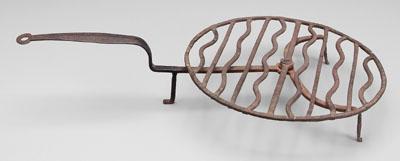 Appraisal: Wrought iron gridiron circular revolving grid on three-footed base attributed