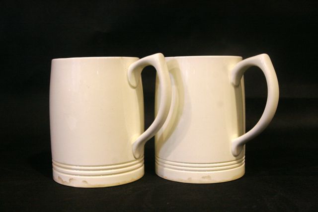 Appraisal: A pair of Wedgewood tankards by Keith Murray in a