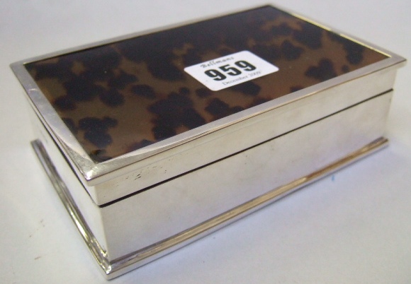 Appraisal: A silver and tortoiseshell lidded rectangular table cigarette box wooden