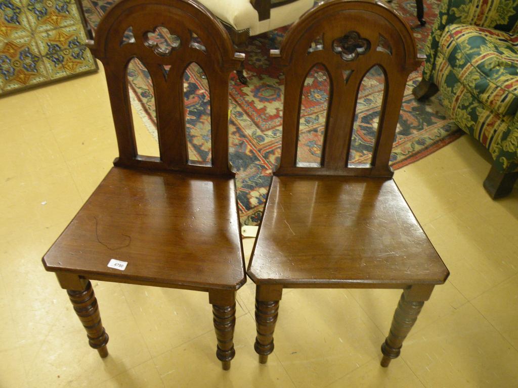 Appraisal: A pair of Victorian mahogany hall chairs each with a