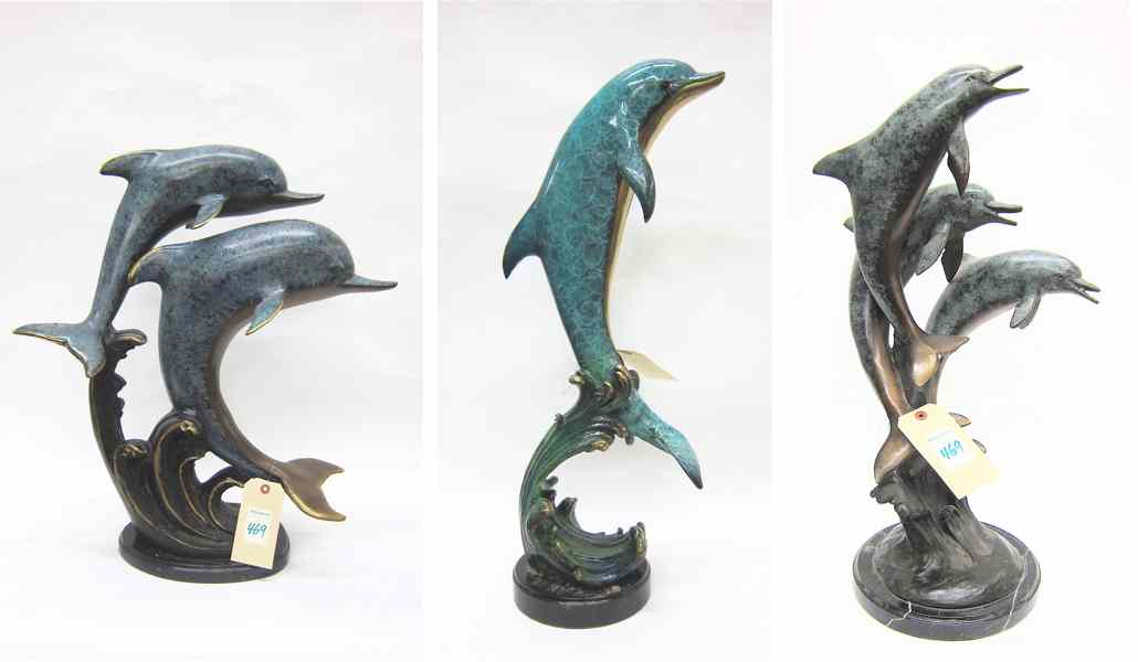 Appraisal: THREE MARINE WILDLIFE BRONZE SCULPTURES all dolphin and dolphin groups