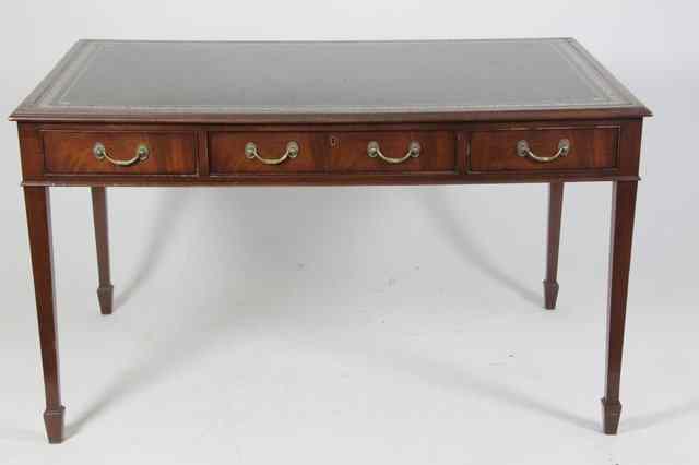 Appraisal: A reproduction mahogany writing table with inset leather panel top