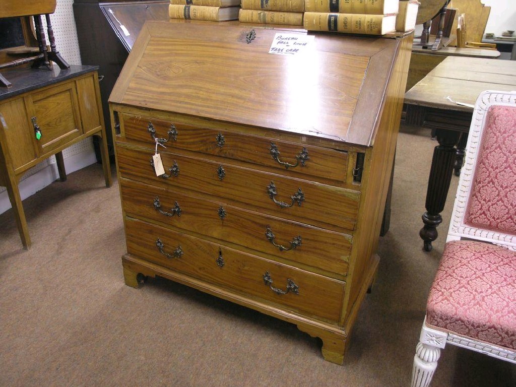 Appraisal: A George III satinwood bureau fall front enclosing an arrangement