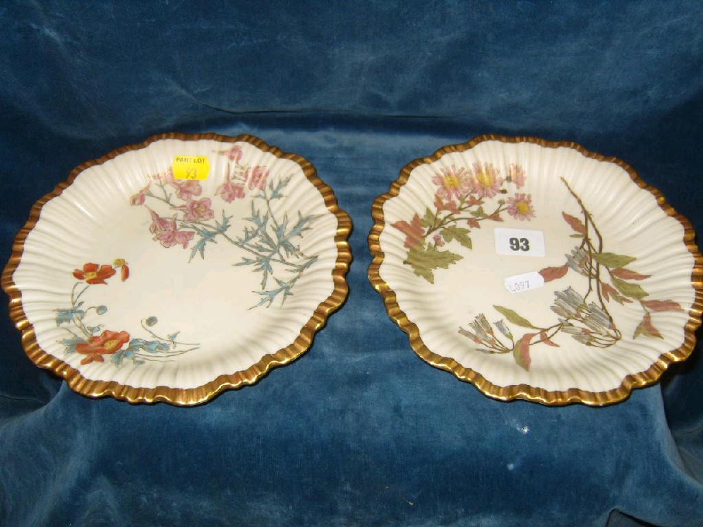 Appraisal: A pair of Royal Worcester ivory coloured dessert plates with