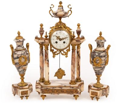 Appraisal: A French clock garniture of veined marble comprising a portico