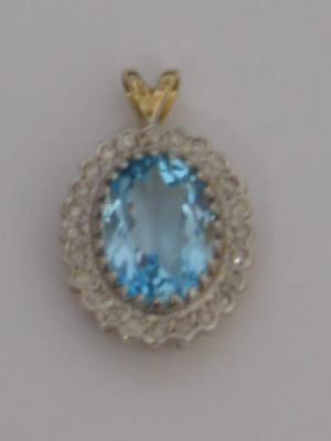 Appraisal: A BLUE TOPAZ AND DIAMOND PENDANT the oval cut topaz