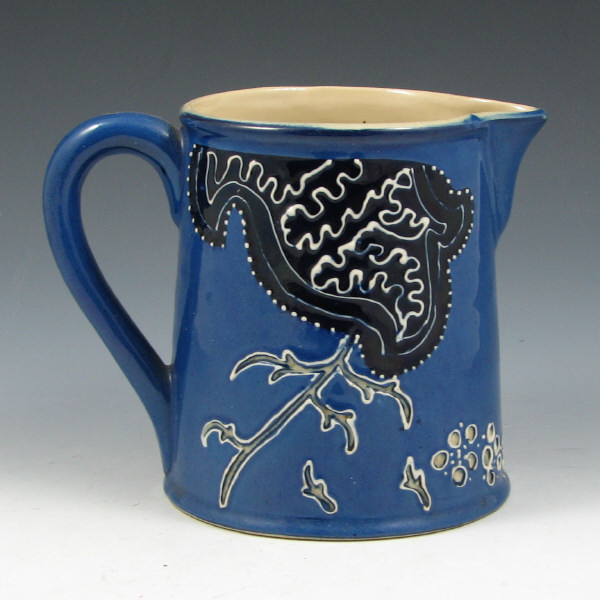 Appraisal: Avon Faience pitcher with stylized bird win dark blue and