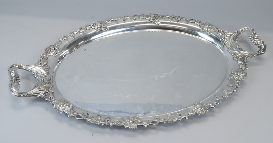 Appraisal: A silver plated two handled tray the border cast with