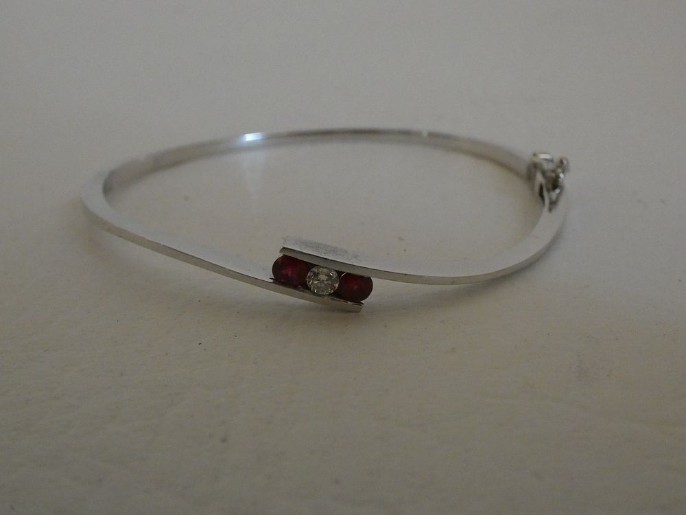 Appraisal: GOLD DIAMOND RUBY BRACELET k white gold bangle bracelet with