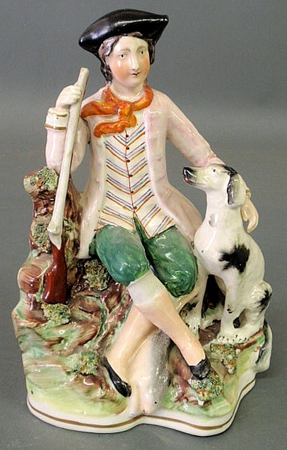 Appraisal: Staffordshire figure of a seated hunter with gun dog and