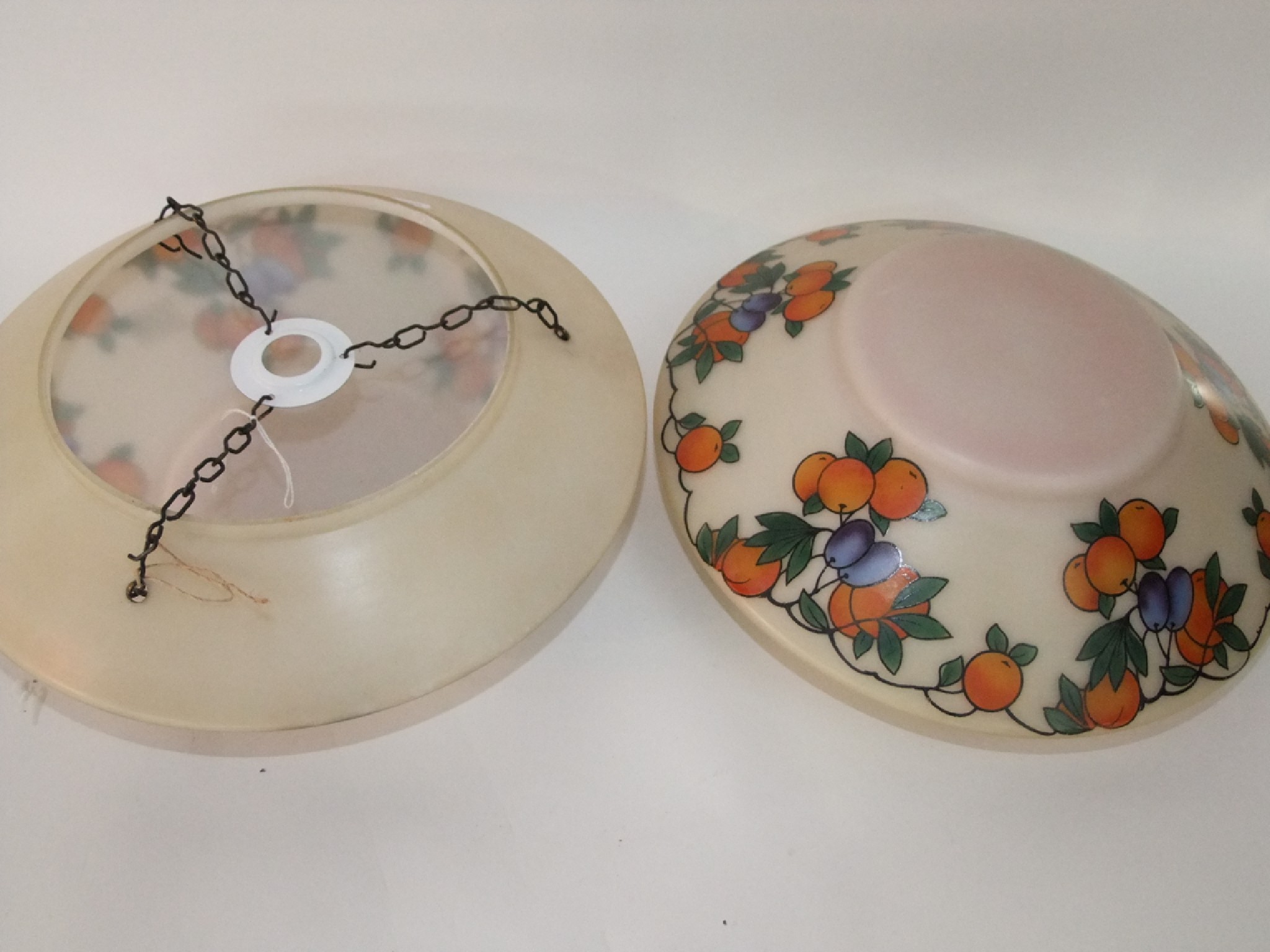 Appraisal: A pair of opaque glass ceiling lightshades decorated with fruiting