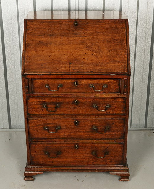 Appraisal: A GEORGE III MAHOGANY SMALL BUREAU the interior fitted pigeon