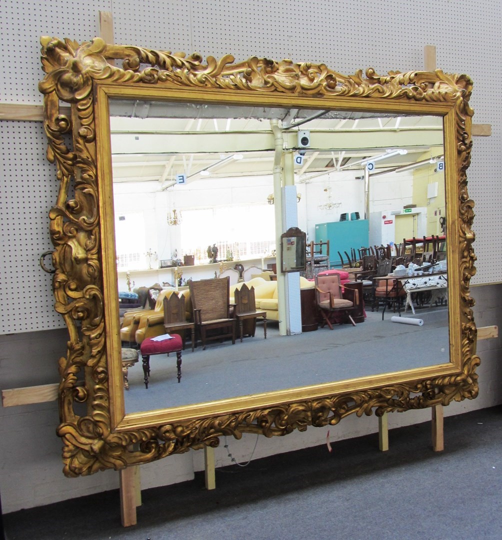 Appraisal: A massive th century gilt framed deep carved wall mirror