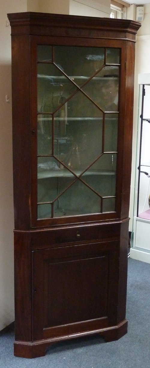 Appraisal: A George III mahogany standing corner cupboard with astragal glazed