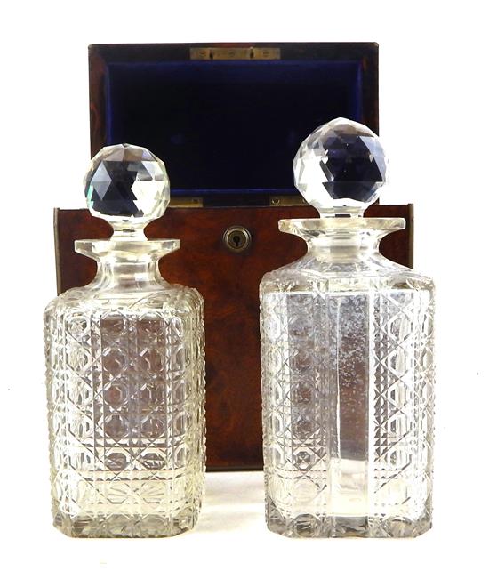 Appraisal: th C English tantalus containing two similar cut glass decanters