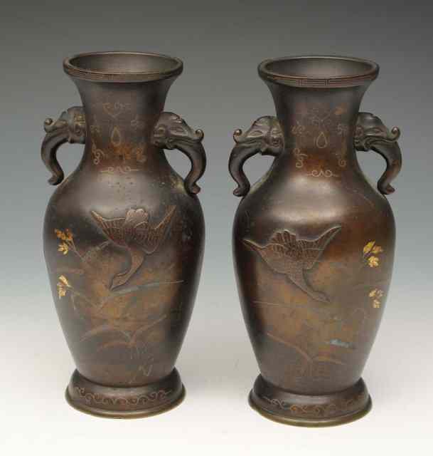 Appraisal: A PAIR OF JAPANESE BRONZE BALUSTER VASES decorated with storks