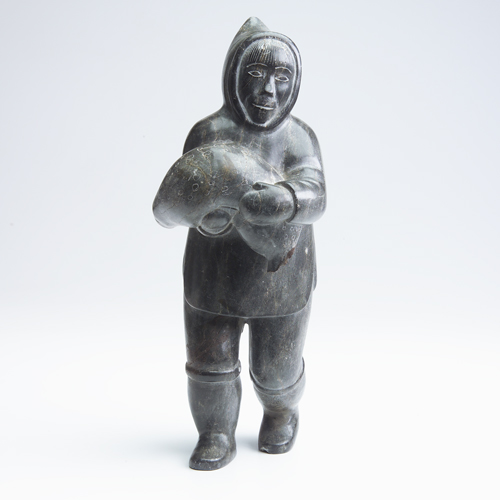 Appraisal: Inuit carving of young boy and seal pup unmarked Losses