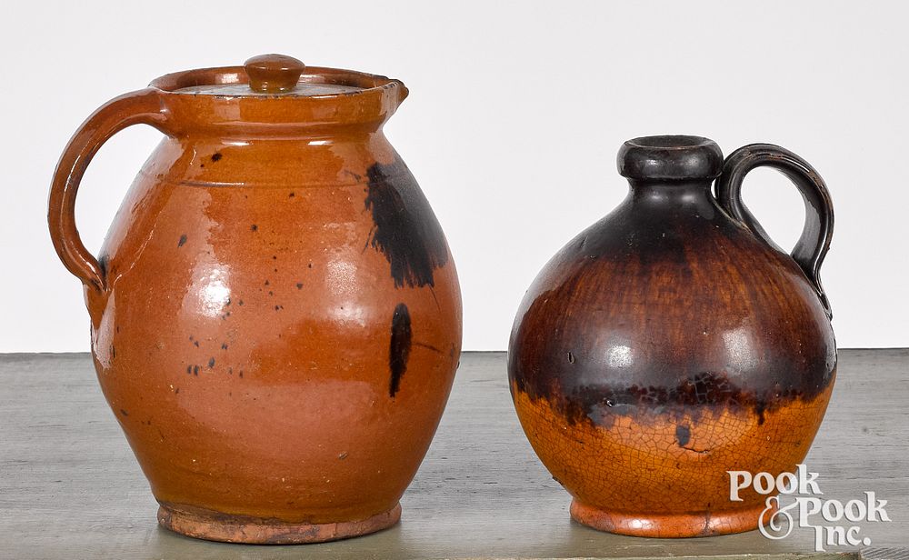 Appraisal: Redware jug and lidded pitcher th c Redware jug and