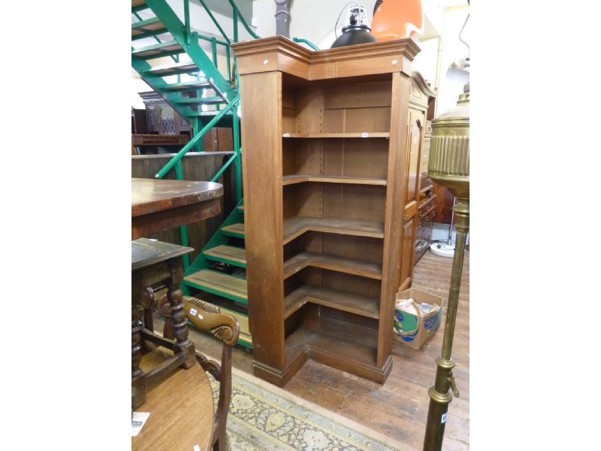 Appraisal: An early th century oak corner bookcase set beneath a