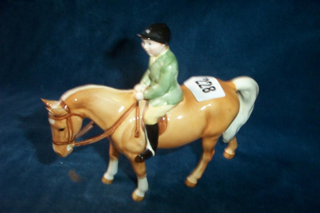 Appraisal: A Beswick model of a green jacketed boy riding on