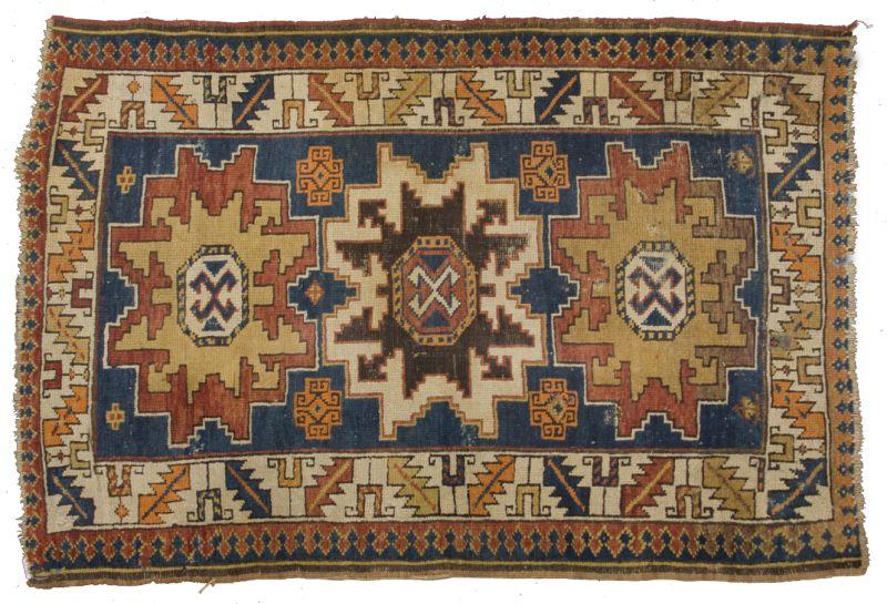 Appraisal: Antique Caucasian Area Rug geometric border enclosing three primary medallions