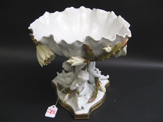 Appraisal: CONTINENTAL GLAZED PORCELAIN CENTERPIECE COMPORT with white shell formed bowl