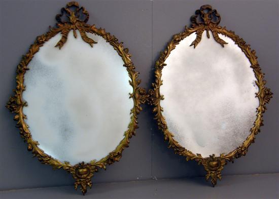 Appraisal: Pair of th century gilt metal framed oval mirrors with