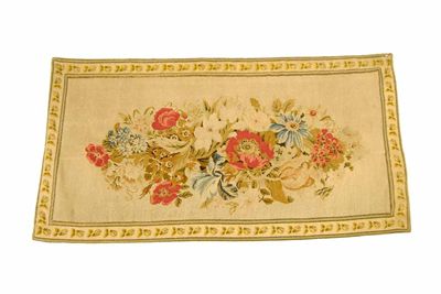 Appraisal: A th century embroidered wall hanging centred a floral bouquet