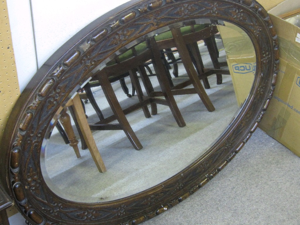 Appraisal: Large oval oak framed wall mirror with blind fret decoration