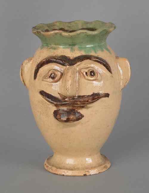 Appraisal: Redware figural vase th c with applied man's face h