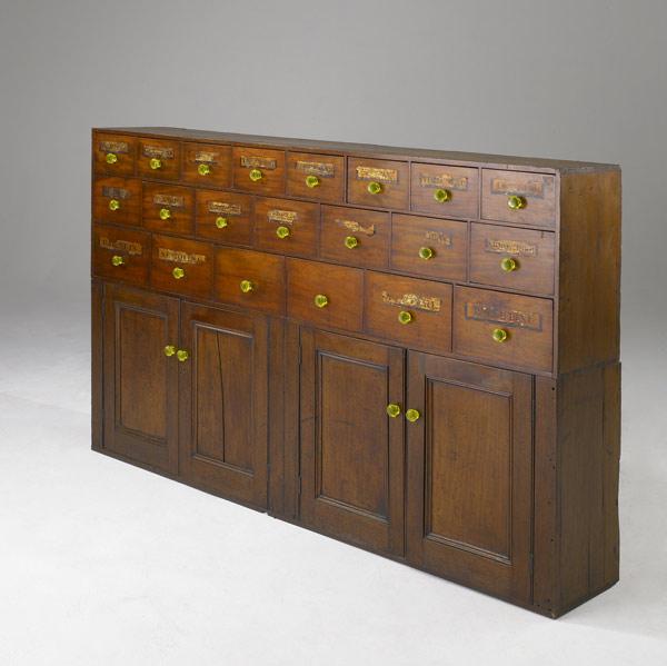 Appraisal: ENGLISH APOTHECARY CABINET Walnut drawer fronts original yellow glass pulls