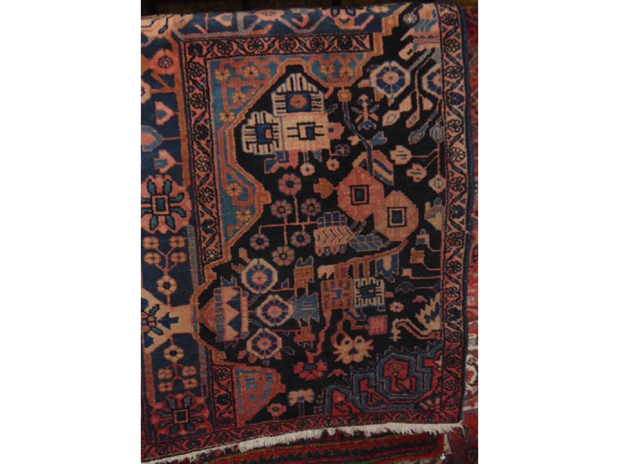 Appraisal: A Persian style wool rug with an ink black field