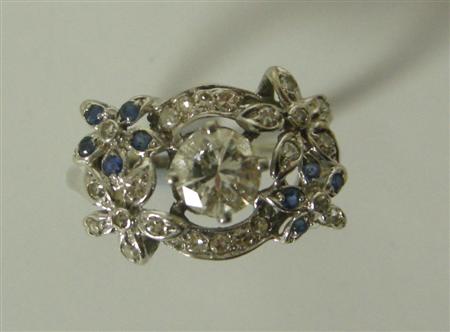 Appraisal: A diamond and sapphire floral ring the central circular cut