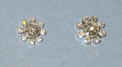 Appraisal: A PAIR OF DIAMOND STUD EARRINGS comprising central brilliant cut