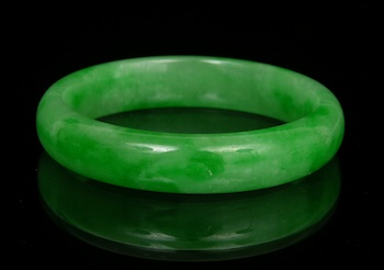 Appraisal: A Carved Jade Bangle Bracelet A carved jade bangle in