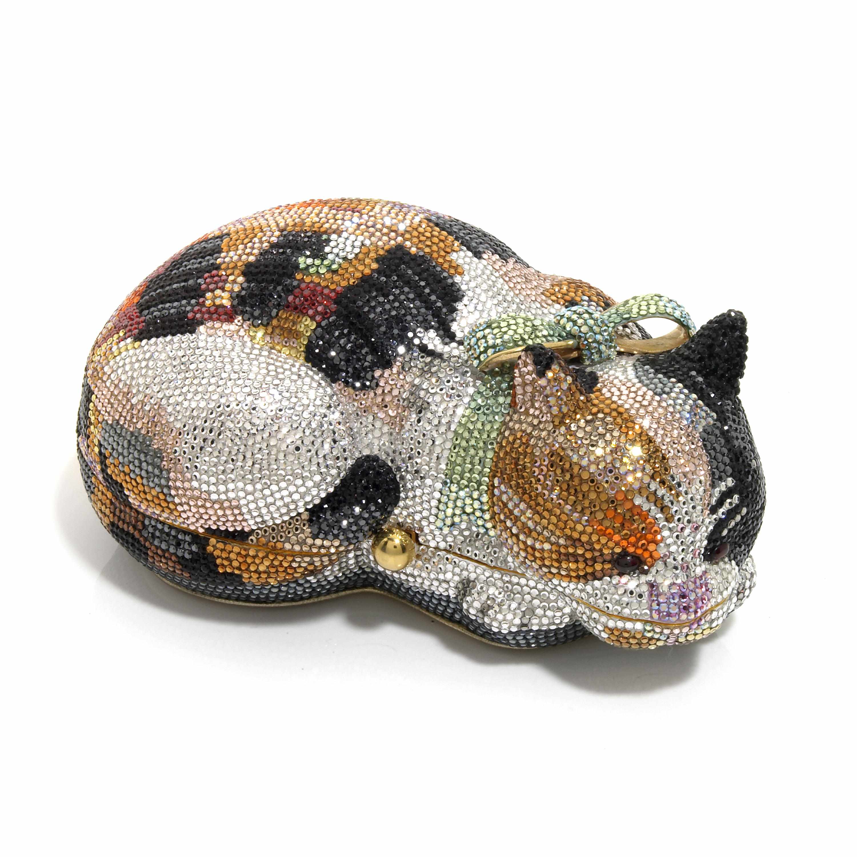 Appraisal: A Calico multi-colored crystal sleeping cat minaudiere with a green