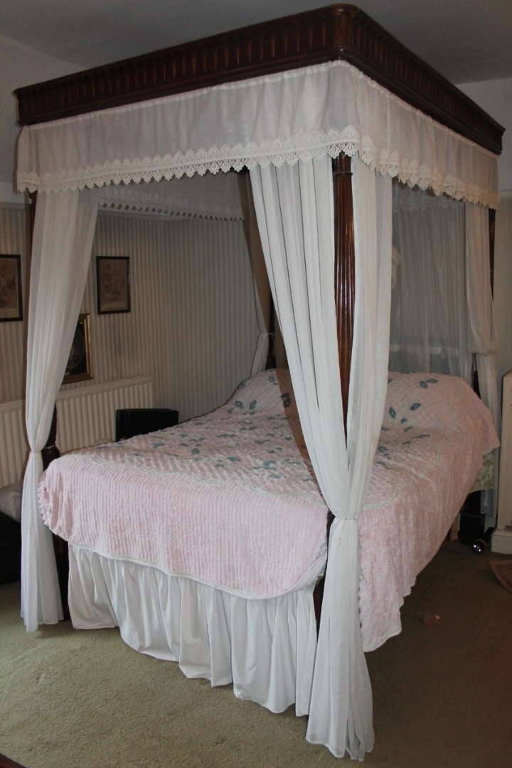 Appraisal: An Edwardian mahogany four poster bed with moulded canopy having