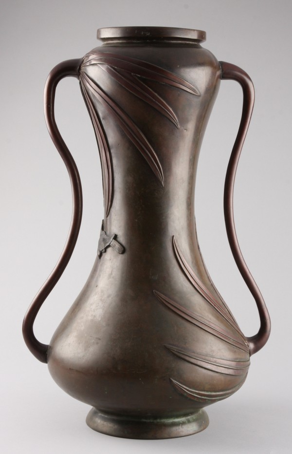 Appraisal: Bronze vase features leaf and flying bird design on body