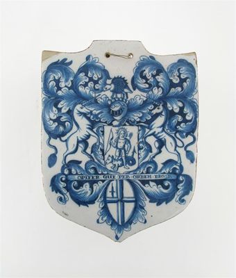 Appraisal: An unusual delftware shield-shaped pill slab painted with the arms