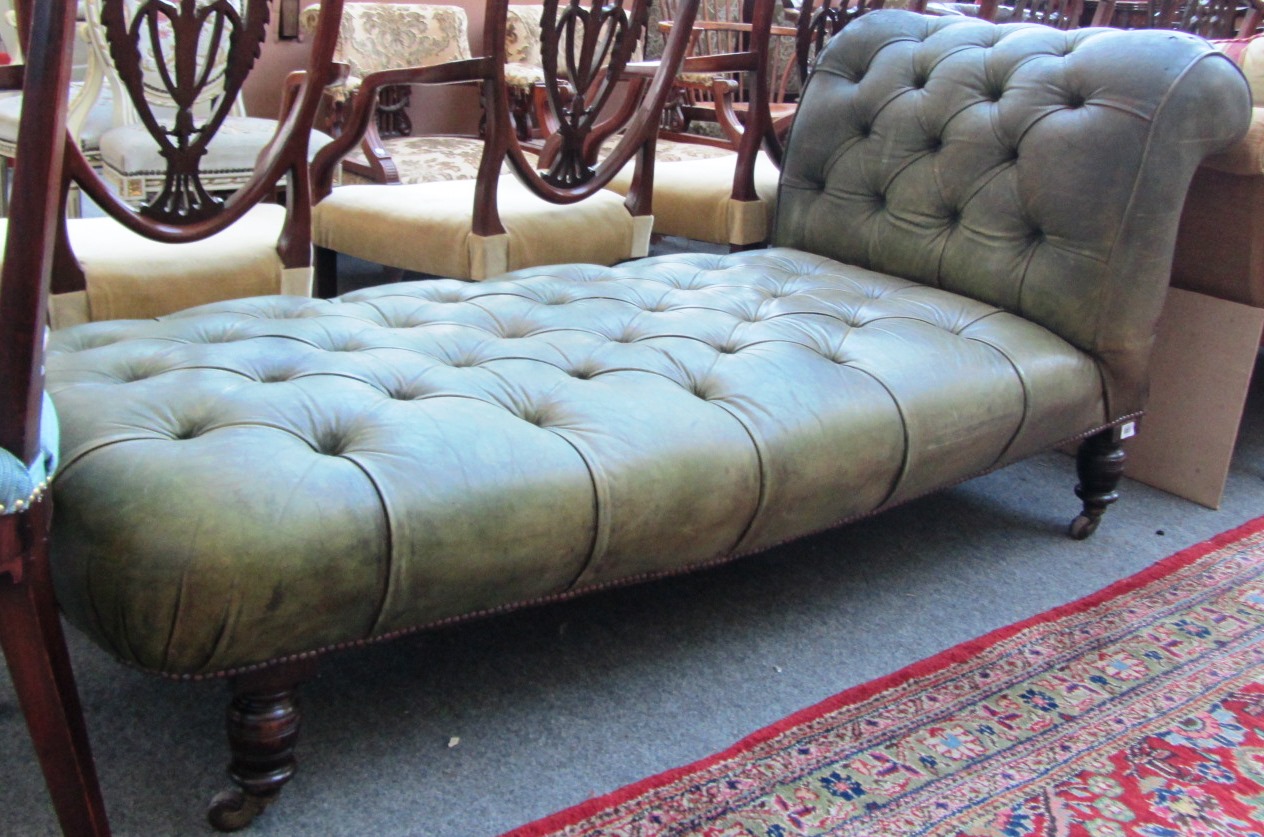 Appraisal: A th century green leather upholstered drop end chaise longue