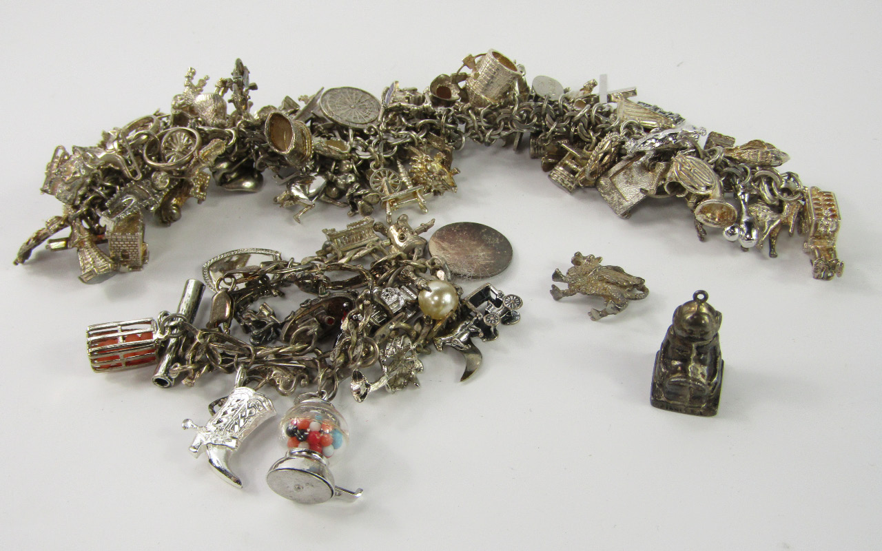 Appraisal: Two silver bracelets containing a quantity of charms as fitted