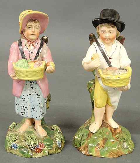 Appraisal: Pair of th c Staffordshire winged figures boy with basket