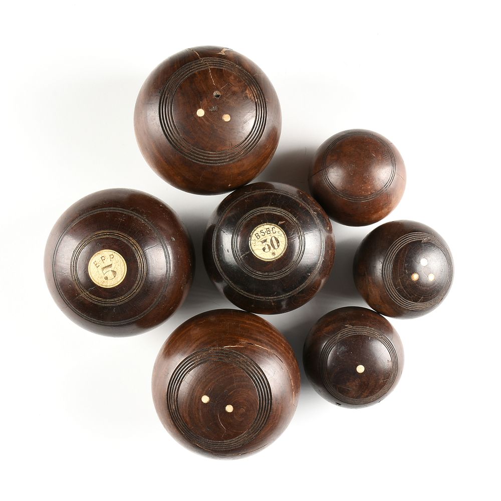 Appraisal: A GROUP OF SEVEN ENGLISH LAWN BOWLS CARVED AND INLAID