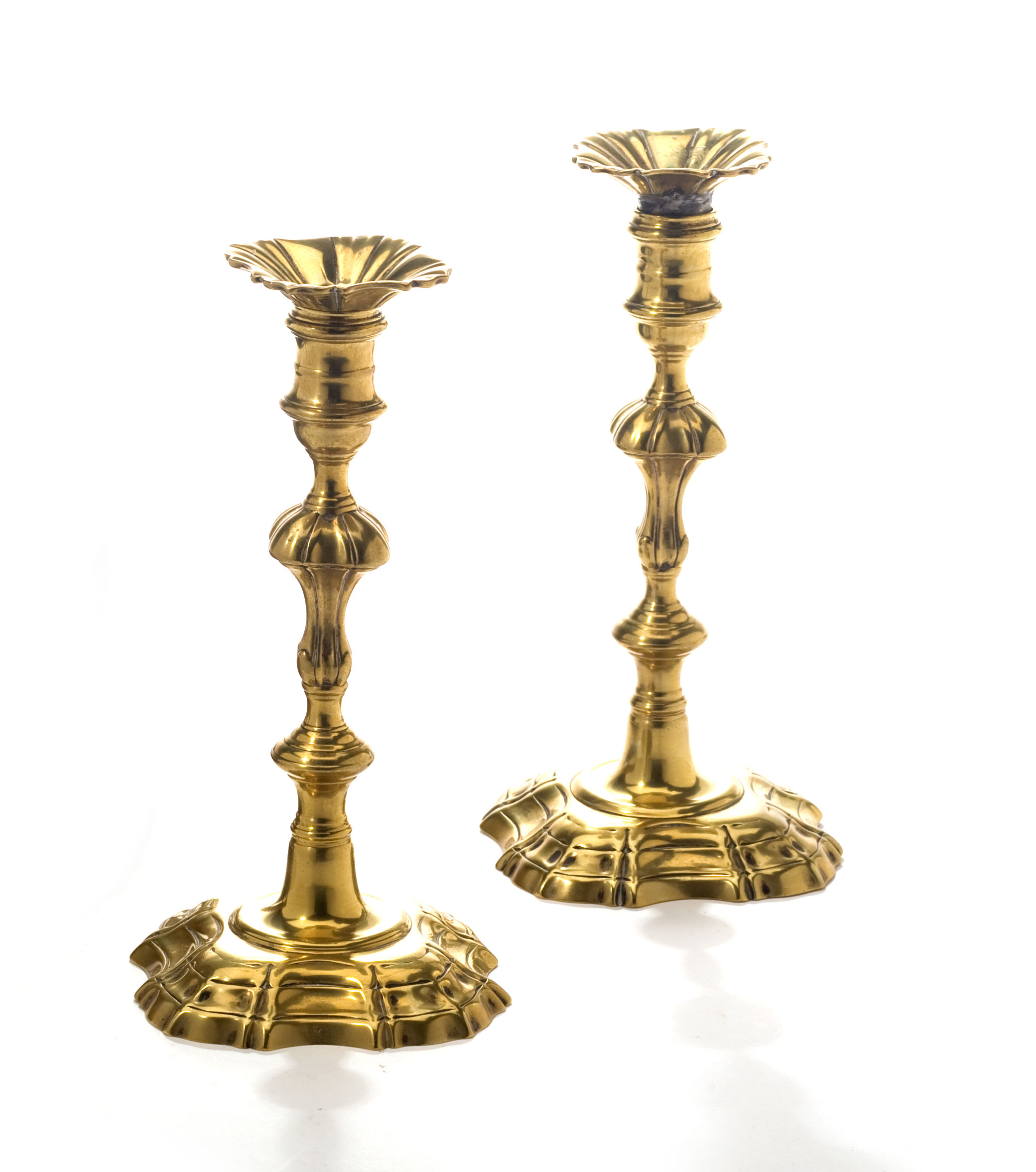 Appraisal: PAIR OF GEORGIAN BRASS CANDLESTICKS Each with traces of engraved