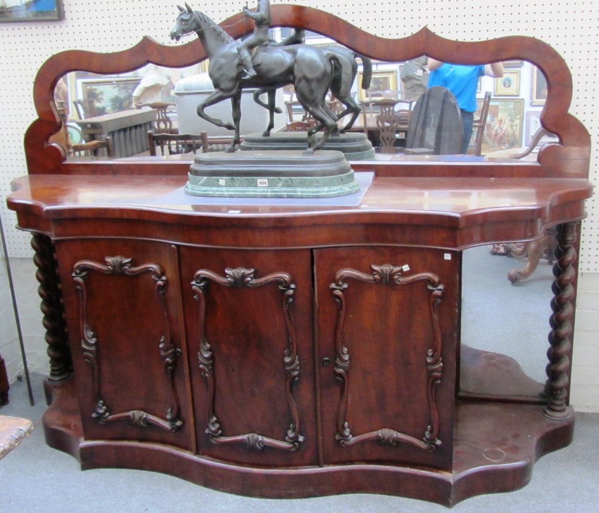 Appraisal: A th century mahogany serpentine mirror back sideboard with barely-twist