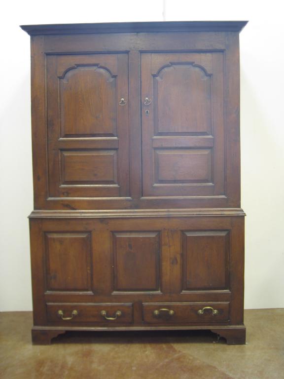 Appraisal: An early th Century Linen Cupboard pair of arched panelled